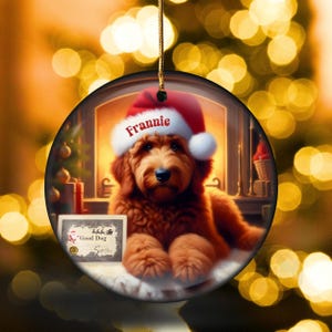 Pu&ograve; includere: Ornamento natalizio rotondo con un cane golden doodle con un cappello da Babbo Natale con il nome "Frannie". Il cane &egrave; di fronte a un camino. Un piccolo cartello recita "Good Dog".