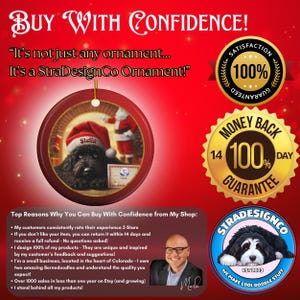 May include: A red Christmas ornament with a gold trim, featuring a black dog in a Santa hat. The ornament has a gold string for hanging and the name "Stella." Text includes "Buy With Confidence" and "StraDesignCo Ornament."