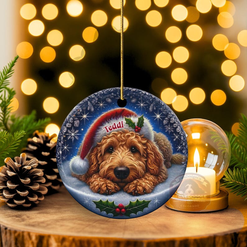 Golden Doodle dog ceramic ornament show hanging with a gold string.  The Goldendoodle Dog ornament measures 3 inches in diameter and is a full gloss, printed on both sides.