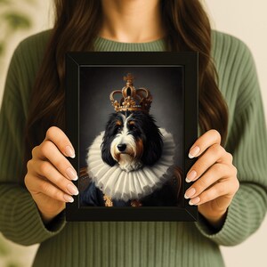 May include: A framed portrait of a dog wearing a gold crown and a ruffled collar. The dog has black, white, and brown fur. The portrait is set against a dark background, creating a regal and elegant aesthetic.