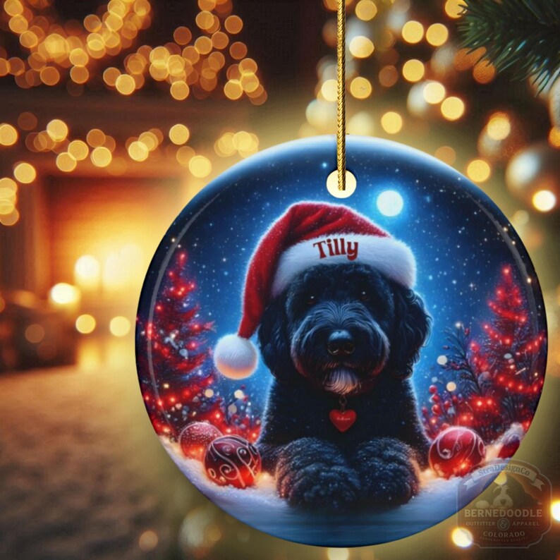 This festive ornament features an adorable black doodle wearing a Santa hat, surrounded by soft glowing holiday lights and rich red Christmas tones. The warm lighting highlights the dog’s fluffy black fur, giving the design a bright, cheerful look that stands out on any tree. A perfect personalized keepsake for anyone who loves black doodles and joyful holiday décor.