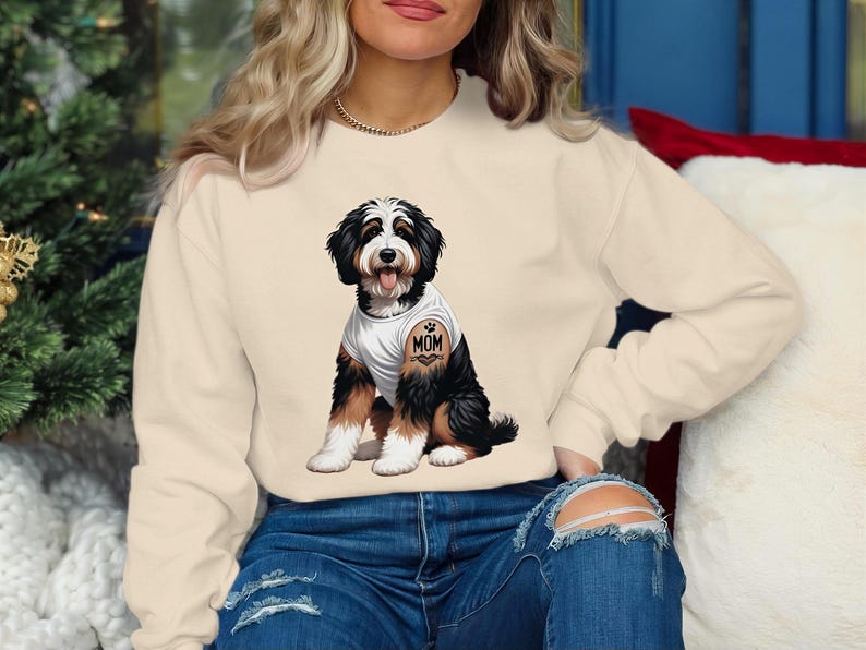 A woman wearing a white sweatshirt with a graphic of a dog on it.