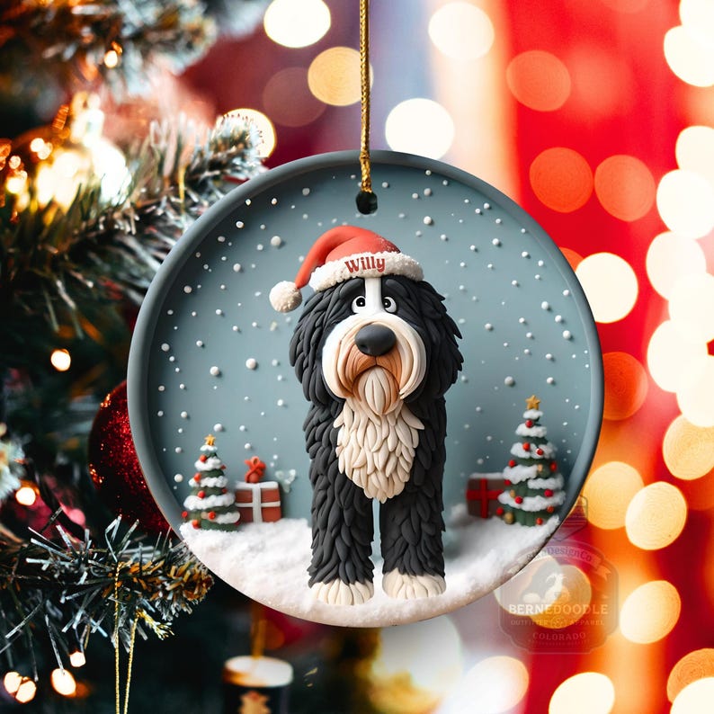 May include: A round Christmas ornament featuring a Bernedoodle dog wearing a Santa hat with the name "Willy". The ornament has a snowy scene with Christmas trees and gifts. The dog is black, white, and brown.