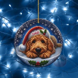 Golden Doodle dog ceramic ornament show hanging with a gold string.  The Goldendoodle Dog ornament measures 3 inches in diameter and is a full gloss, printed on both sides.