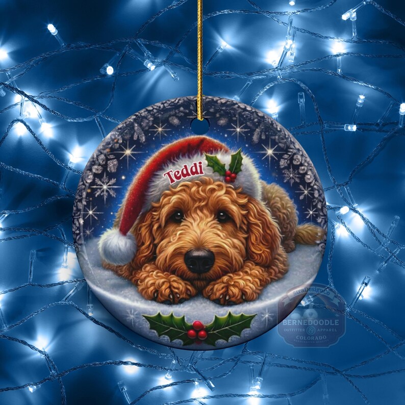 Golden Doodle dog ceramic ornament show hanging with a gold string.  The Goldendoodle Dog ornament measures 3 inches in diameter and is a full gloss, printed on both sides.