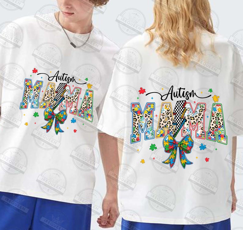 May include: Two white t-shirts with a colorful graphic design featuring the words "Autism Mama" with a puzzle piece pattern and a lightning bolt. The design includes a bow made of puzzle pieces.