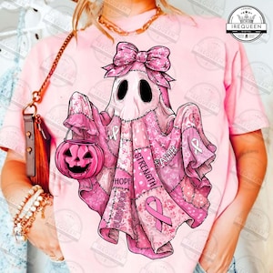 May include: Pink ghost design with a bow, holding a jack-o'-lantern. The ghost is decorated with pink ribbons and the words "Hope", "Strength", "Faith", and "Survivor". A breast cancer awareness theme.