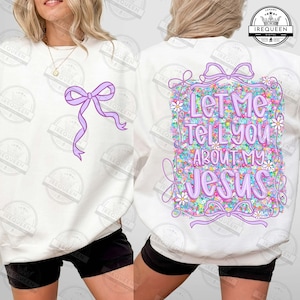 May include: White sweatshirt with a purple bow and the text "Let Me Tell You About My Jesus" on the back. The design includes floral and ribbon accents, creating a colorful and faith-based aesthetic.