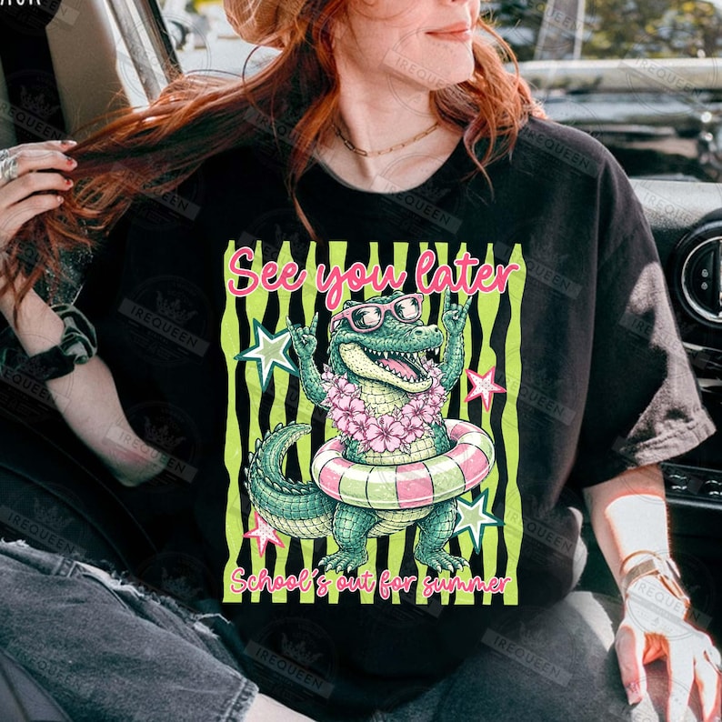 May include: Black t-shirt featuring a cartoon alligator wearing sunglasses and a floral lei, inside a pink and white striped inner tube. The text "See you later" and "School's out for summer" are also displayed.