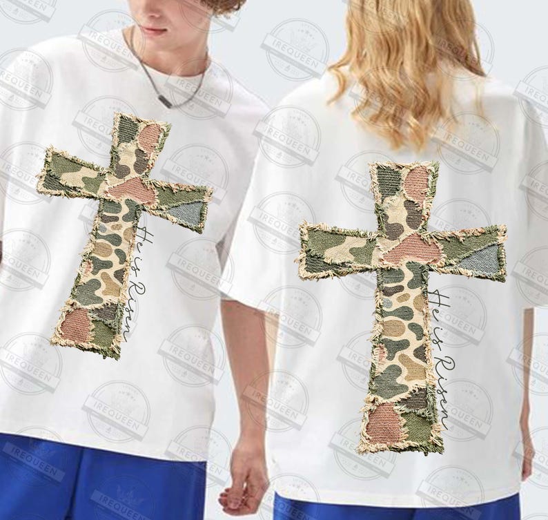 May include: White t-shirts with a large, camouflage-patterned cross design on the front and back. The text "He is Risen" is printed vertically on the right side of the cross. The cross has a distressed, frayed edge.