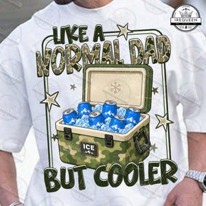 May include: White t-shirt with the text "LIKE A NORMAL DAD BUT COOLER" in a camouflage design. The graphic includes a cooler filled with ice and blue cans. The cooler has a green camouflage pattern.