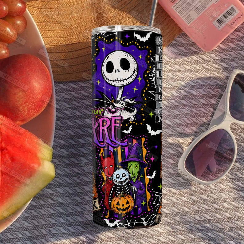 May include: A cylindrical stainless steel tumbler featuring a vibrant purple and black graphic print of characters from The Nightmare Before Christmas, including Jack Skellington, a pumpkin, and various spooky motifs with white bats and spiderwebs.