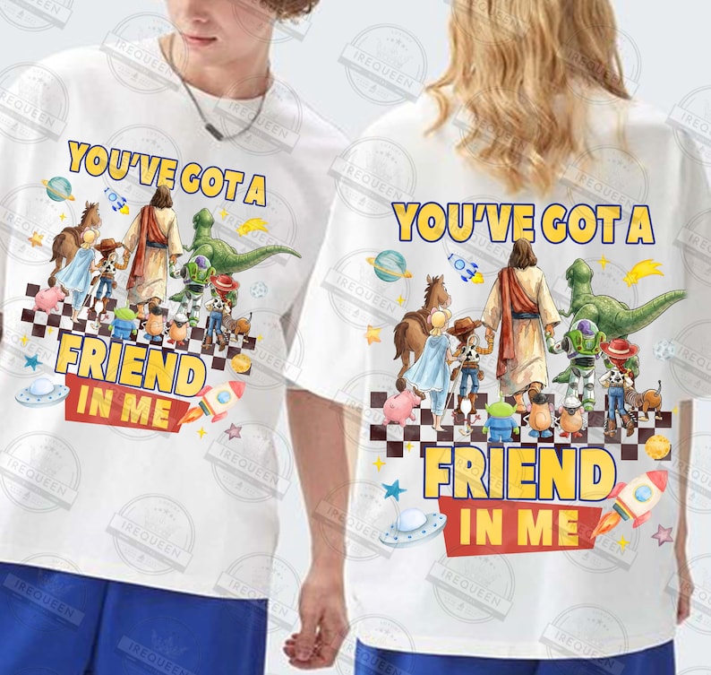 May include: White t-shirts with a colorful graphic featuring the text "YOU'VE GOT A FRIEND IN ME" and cartoon characters. The design includes a rocket, a spaceship, and a checkerboard pattern.