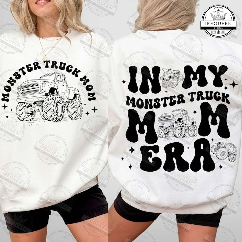 May include: White sweatshirt with black text that reads "Monster Truck Mom" on the front and "In My Monster Truck Mom Era" on the back. The sweatshirt features a black and white illustration of a monster truck on the front.