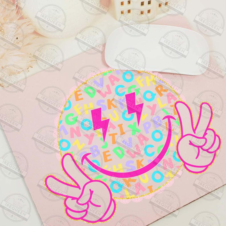 May include: A pink and yellow graphic design featuring a smiley face with a peace sign hand gesture. The smiley face has a colorful alphabet pattern and two pink lightning bolts. The design is on a pink background.