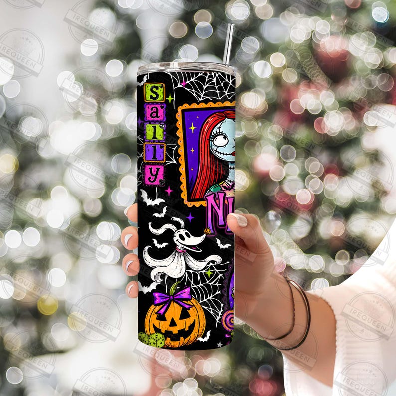 May include: A cylindrical tumbler featuring a black background with a white spiderweb pattern, a graphic of a character with long red hair, a white ghost dog, and an orange jack-o'-lantern. The text Sally is printed vertically in green.