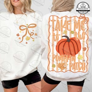 May include: White sweatshirt with a fall-themed design. The front features a bow and autumn leaves. The back displays a pumpkin graphic with the text "Take Me to the Pumpkin Patch".