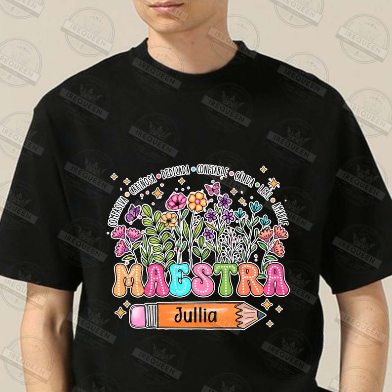 May include: Black t-shirt with a colorful floral design and the word "MAESTRA" in rainbow letters. A large pencil with the name "Jullia" is below the floral design. The words "compasivia, cari&ntilde;osa, dedicada, confiable, c&aacute;lida, leal, amable" are written around the floral design.