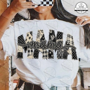 May include: White t-shirt featuring the word "mama" in a patchwork design. The letters are made of various black and white patterned fabrics, including polka dots, floral, and plaid. A stylish and comfortable top.