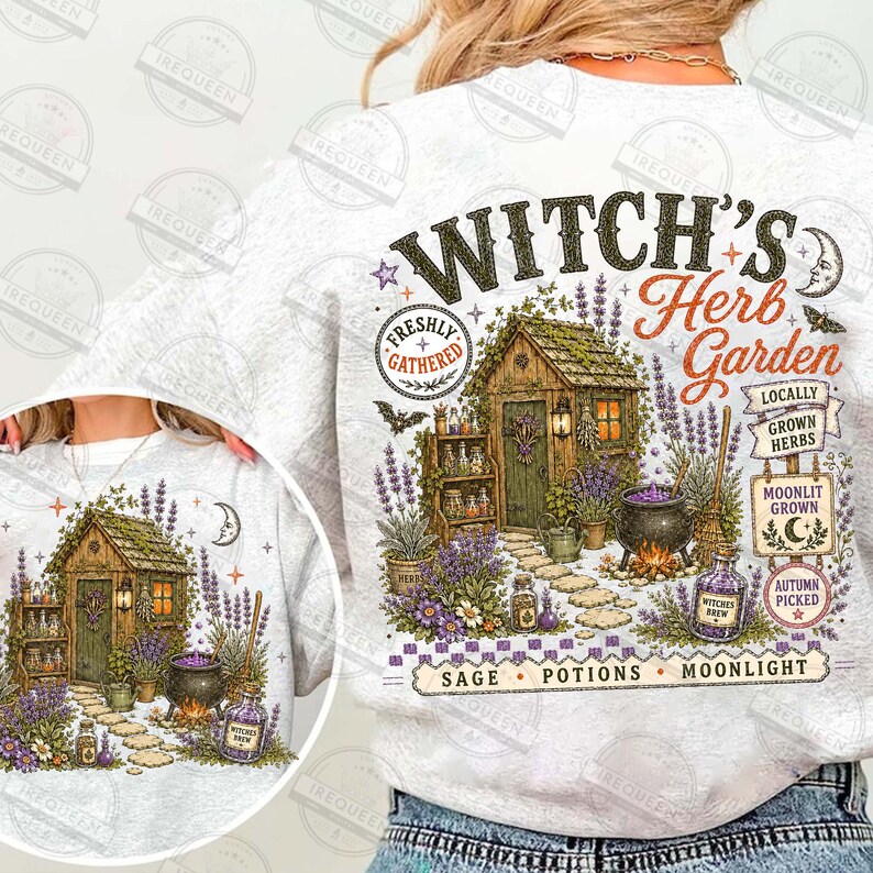 May include: A light gray sweatshirt featuring a graphic print of a wooden shed surrounded by lavender, a cauldron, and text that reads Witch's Herb Garden, Freshly Gathered, Locally Grown Herbs, Moonlit Grown, Autumn Picked, Sage, Potions, Moonlight.
