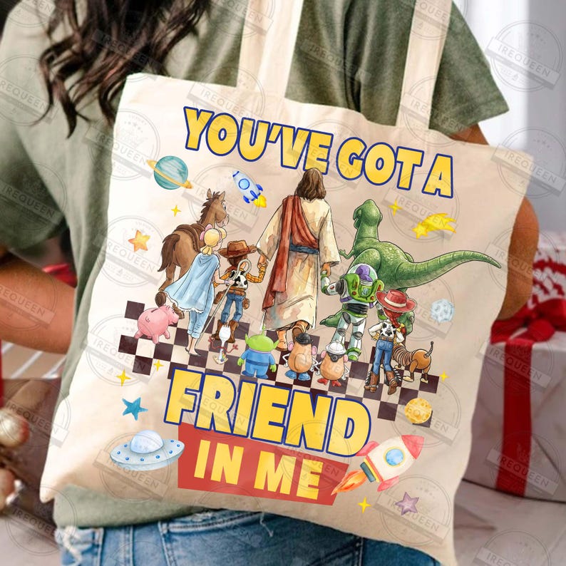 May include: Beige tote bag featuring the text "YOU'VE GOT A FRIEND IN ME" in yellow and red. The design includes illustrations of various characters and a checkerboard pattern. A fun and colorful accessory.