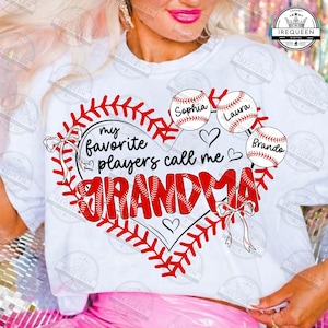 May include: White t-shirt with a baseball-themed design. The design features a heart shape made of baseball stitching, the words "my favorite players call me GRANDMA", and baseballs with the names "Sophia", "Laura", and "Brando".