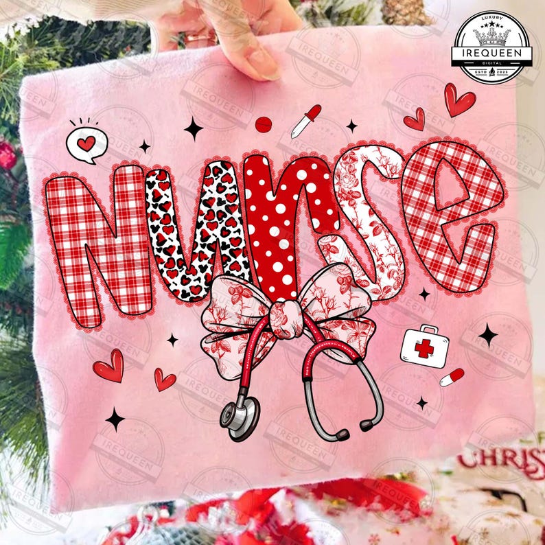 May include: Pink t-shirt with the word "NURSE" in a decorative font. The letters feature patterns like red plaid, hearts, and polka dots. A bow and stethoscope are also included in the design, along with medical-themed graphics.