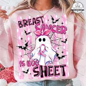 May include: A light pink sweatshirt featuring a graphic of a white ghost wearing a pink bow and a pink breast cancer awareness ribbon. The design includes black bats, spider webs, and the text BREAST CANCER IS BOO SHEET in black and pink.