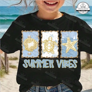 May include: Black t-shirt featuring three framed illustrations of a seashell, sea turtle, and starfish, with a light blue background. The text "SUMMER VIBES" is displayed in light blue and yellow.