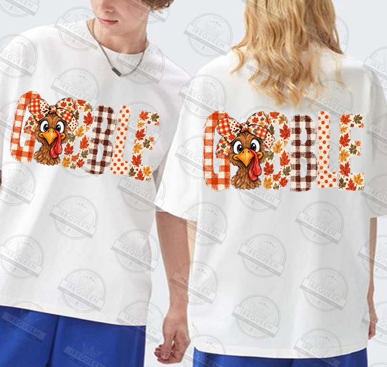 May include: A white short-sleeved t-shirt featuring the word GOBBLE printed in large letters. The letters are filled with a pattern of orange and brown plaid, polka dots, and autumn leaves. A cartoon turkey wearing a plaid bow is integrated.