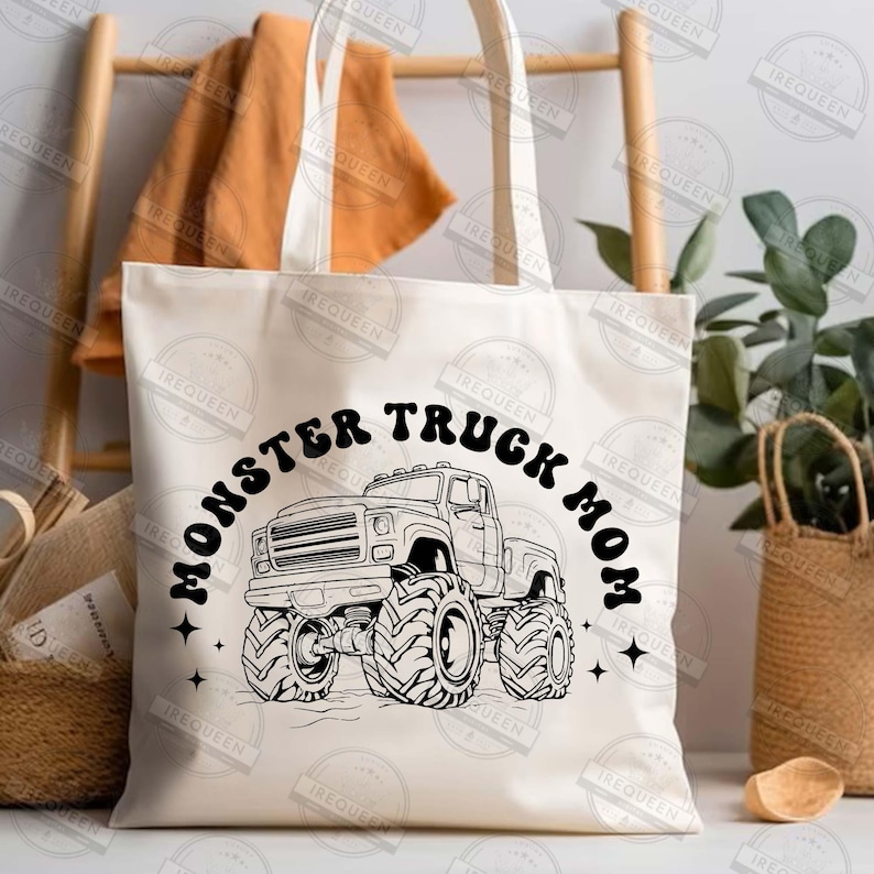 May include: A white canvas tote bag with black text that reads "Monster Truck Mom" and a black line drawing of a monster truck with large tires.