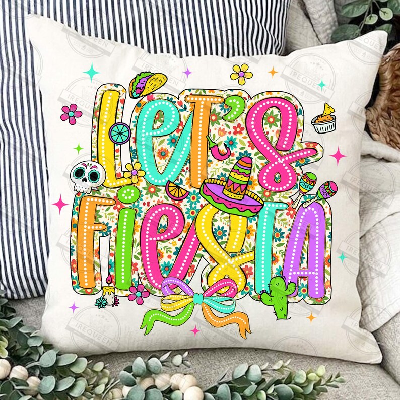 May include: A cushion cover with the phrase "Let's Fiesta" in bright, outlined lettering. The design features a sombrero, maracas, a taco, and floral patterns on a white backdrop.