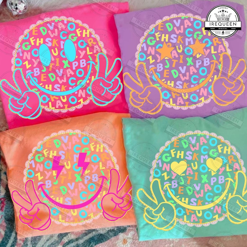 May include: Four colorful t-shirts with a smiley face design. Each shirt features a different color: pink, purple, orange, and green. The smiley face is surrounded by a circle of letters and numbers, with peace signs and various eye designs.