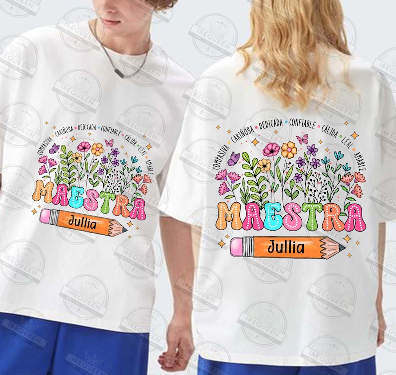 May include: White t-shirt with a colorful graphic of the word "MAESTRA" surrounded by flowers and butterflies. The graphic also includes a pencil with the name "Jullia" written on it. The text around the word "MAESTRA" reads "compasivia, cari&ntilde;osa, dedicada, confiable, c&aacute;lida, leal, amable".