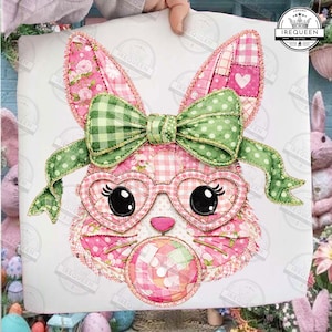 May include: A pink and green patchwork bunny design with heart-shaped glasses and a green bow. The bunny is blowing a bubblegum bubble. The design includes floral and gingham patterns. The image has the text "IREQUEEN" in a circle.