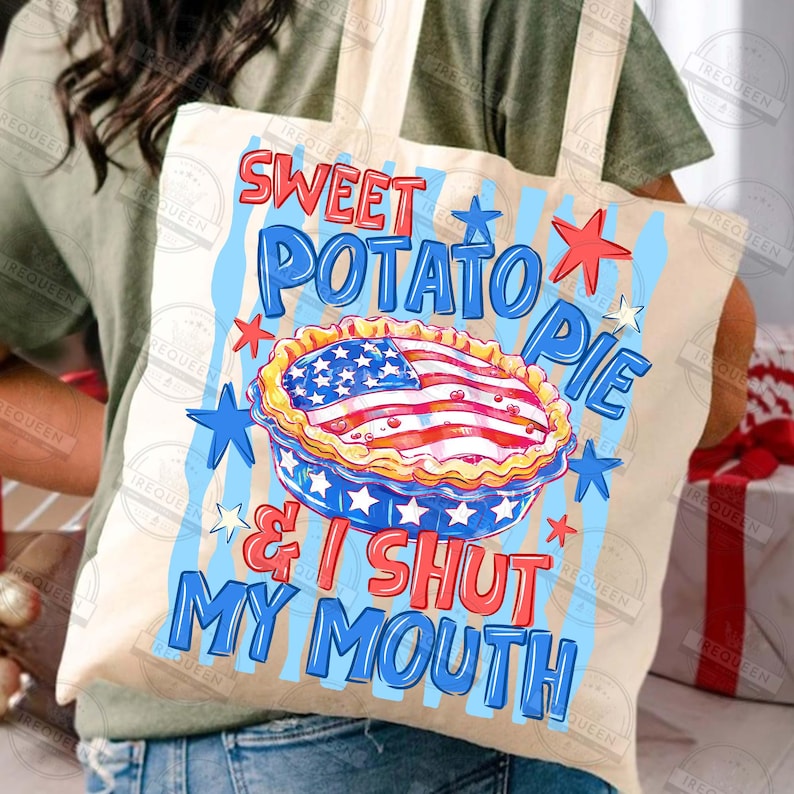 May include: A beige tote bag with a patriotic design. The bag features the text "Sweet Potato Pie & I Shut My Mouth" in blue and red, along with a pie graphic resembling the American flag. Blue and red stars decorate the design.