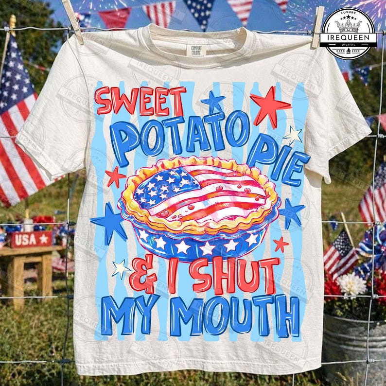 May include: Cream-colored t-shirt with a patriotic design. The graphic features a sweet potato pie decorated with an American flag, surrounded by stars and the text "Sweet Potato Pie & I Shut My Mouth."