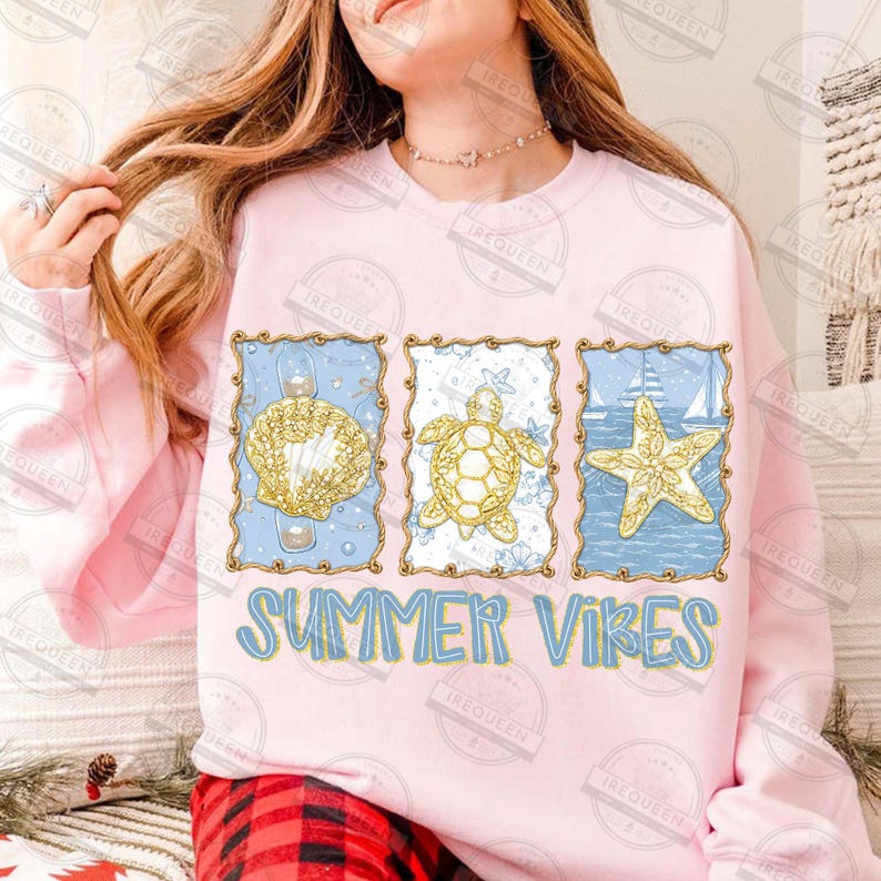 May include: A light pink sweatshirt with a blue and gold design featuring a seashell, turtle, and starfish. The words "SUMMER VIBES" are printed in blue below the images.