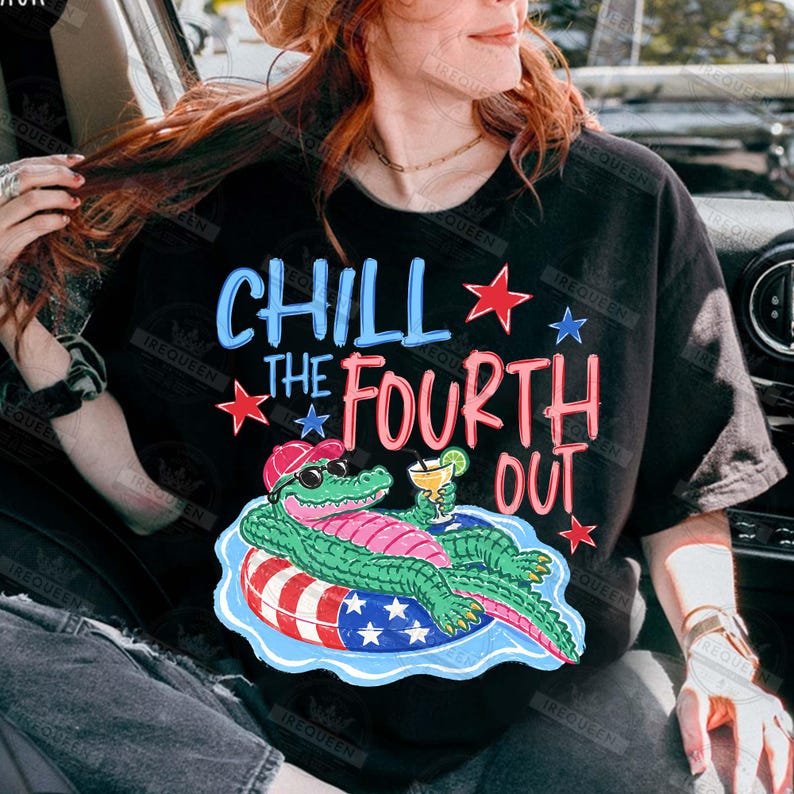 May include: Black t-shirt featuring the phrase "CHILL THE FOURTH OUT" in blue and pink, with red and blue star accents. A cartoon alligator in sunglasses and a hat is on an inflatable ring with a cocktail.