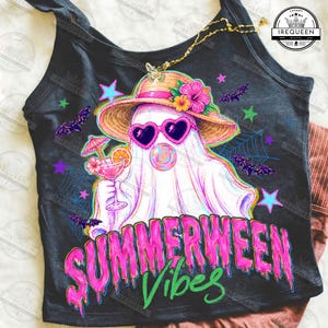 May include: Black tank top with a graphic of a ghost wearing heart-shaped sunglasses and a straw hat, holding a cocktail. The text "SUMMERWEEN Vibes" is in pink and green. Bats, stars, and spiderwebs decorate the design.