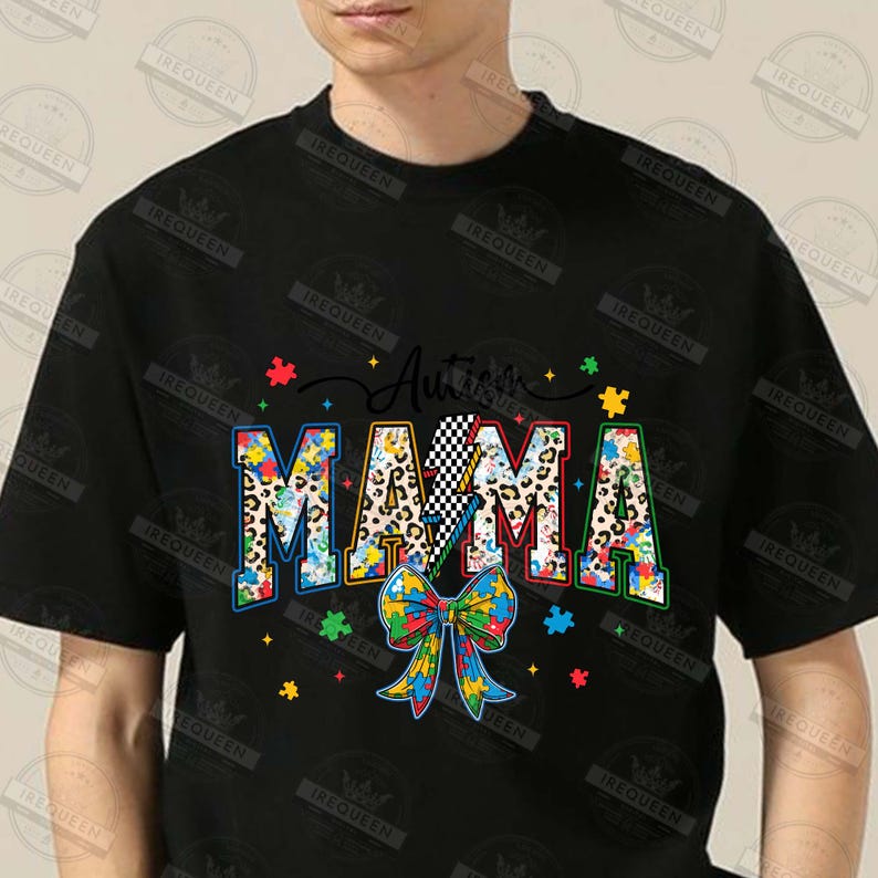 May include: Black t-shirt with the text "Autism Mama" in colorful puzzle piece letters. The letters are decorated with leopard print and a lightning bolt. A blue, yellow, and green puzzle piece bow is below the text.