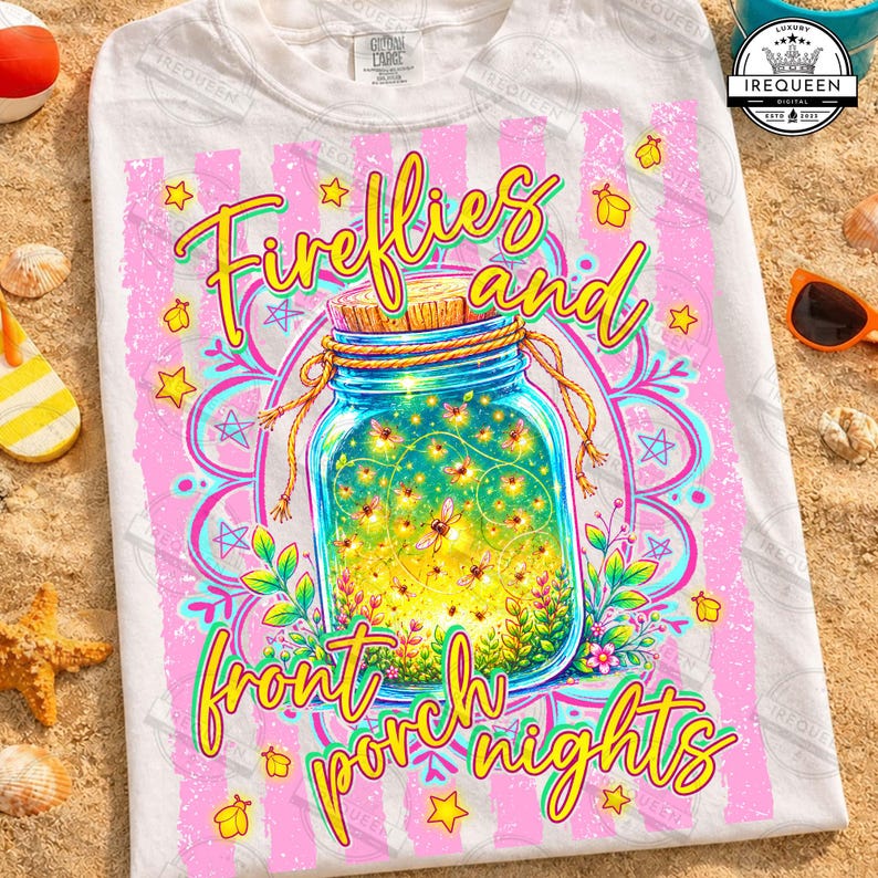 May include: White t-shirt featuring a vibrant graphic of a mason jar filled with glowing fireflies. The design includes the words "Fireflies and front porch nights" in a playful font, surrounded by stars and floral elements.