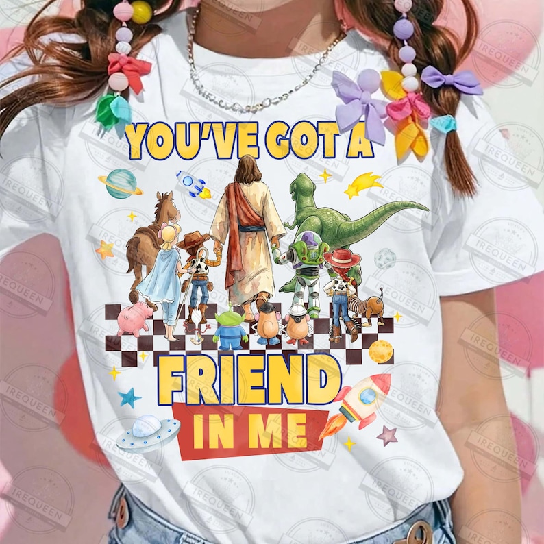 May include: White t-shirt with the text "YOU'VE GOT A FRIEND IN ME" in yellow and red. The shirt features cartoon characters including Jesus, a dinosaur, and characters from Toy Story. A rocket and stars are also included.