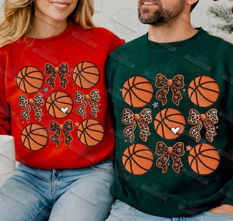 May include: Red and green sweatshirts with basketball and bow designs. The basketballs are orange with black lines. Some bows have a leopard print pattern, and some have a black pattern. Each sweatshirt has a white heart.
