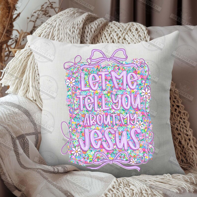 May include: A square decorative pillow with the text "Let Me Tell You About My Jesus" in purple. The text is on a floral background with a purple bow design. The pillow is on a neutral-colored surface.