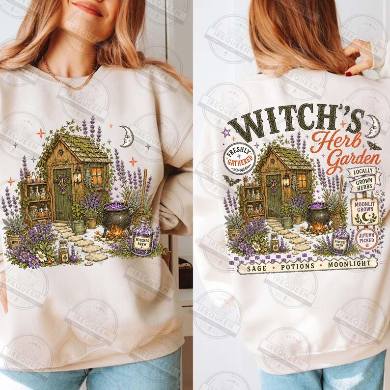 May include: A cream-colored crewneck sweatshirt featuring a graphic of a wooden shed surrounded by lavender, a cauldron, and various herbs. The text reads Witch's Herb Garden, Locally Grown Herbs, Moonlit Grown, Autumn Picked, Sage, Potions, Moonlight.
