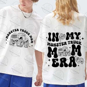 May include: Two white t-shirts with black text and graphics. One shirt says "Monster Truck Mom" with a monster truck graphic. The other shirt says "In My Monster Truck Mom Era" with a monster truck graphic.