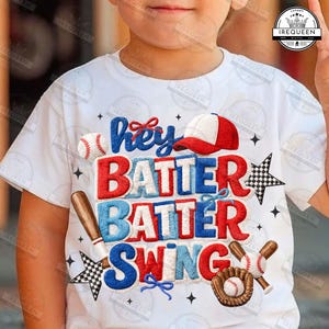 May include: White t-shirt with a baseball theme. The shirt features the text "Hey Batter Batter Swing" in red and blue, along with baseball-related graphics like a baseball, bat, glove, and cap.