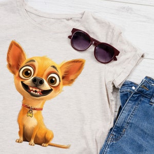 May include: A light grey t-shirt with a cartoon image of a smiling chihuahua wearing a red collar with a bone charm. The chihuahua has large brown eyes and a light brown and orange coat. A pair of dark brown sunglasses are lying on the t-shirt.