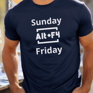 May include: A navy blue t-shirt with white text that reads "Sunday Alt+F4 Friday".